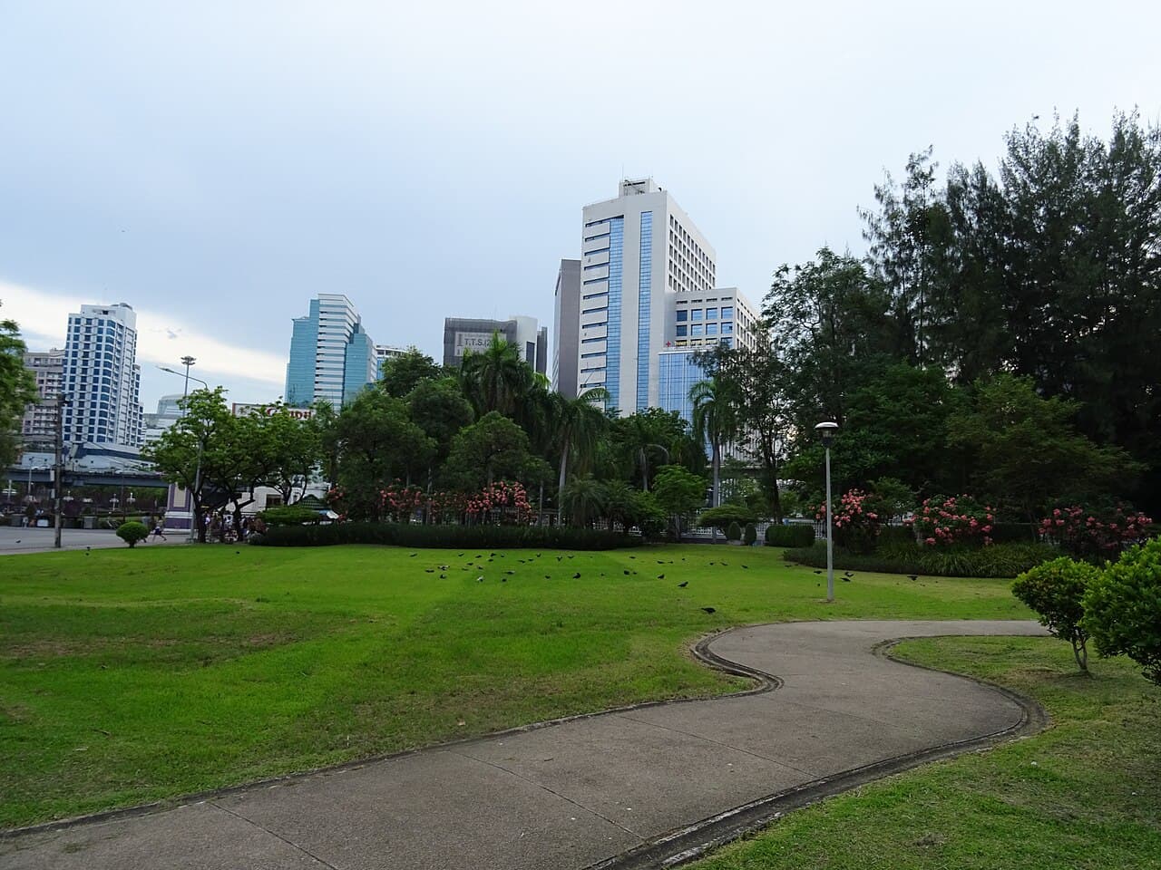 Paths, lawns and city buildings at Lumphini Park in Bangkok, photographed in May 2018