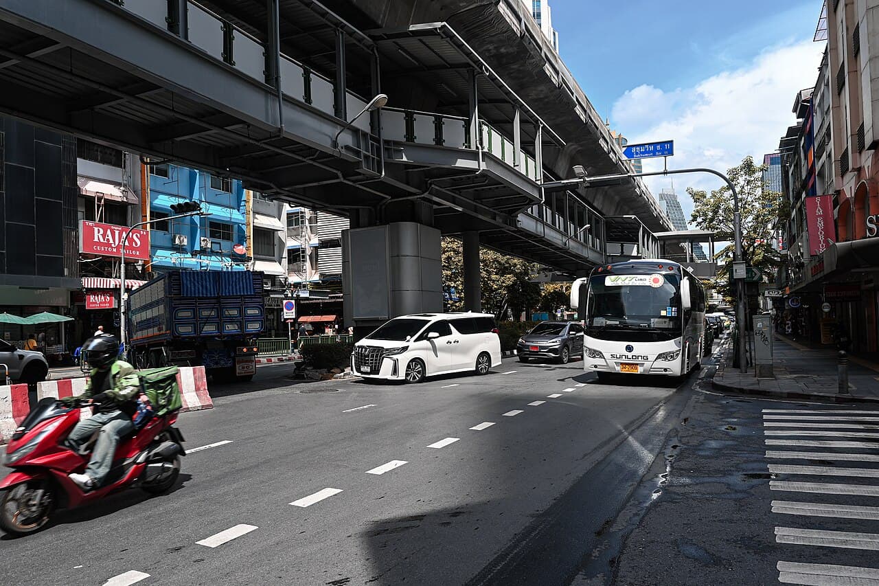 Sukhumvit Road beneath Nana BTS station in Bangkok, photographed in August 2023